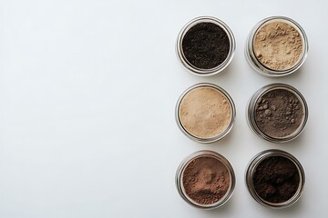 A set of six jars with different shades of cosmetic powder