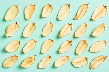 Pattern made of dry petals on pastel green background