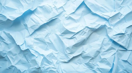 Fototapeta premium Crumpled blue paper texture: abstract background design with light blue creases