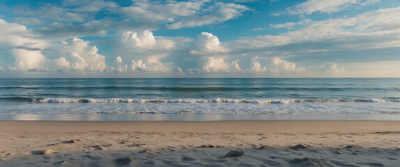 Fototapeta premium Serene Beach Landscape with Gentle Waves and Dramatic Clouds Ideal for Coastal Promotion or Relaxation Themes with Copy Space for Text