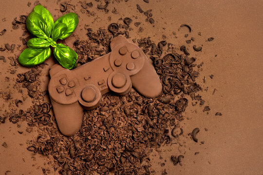 Chocolate Game Controller with Basil on Cocoa Background