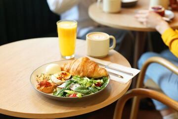 Women having tasty breakfast in cafe, selective focus