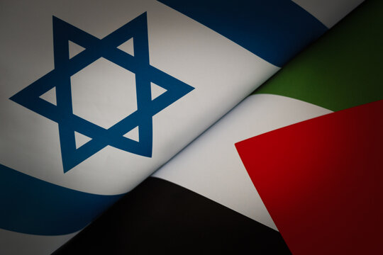 Flags of Israel and Palestine painted on cracked wall background. Concept of the Conflict between Israel and the Palestinian Authorities.