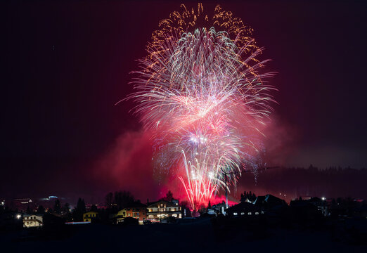 fireworks in the night winter sky in venetian alps