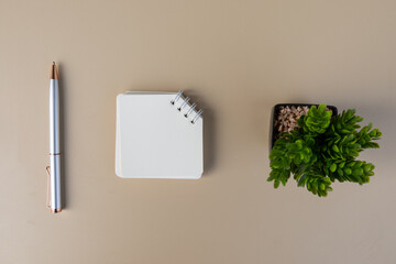 A plain note positioned on a neutral-toned background, perfect for customizable text, branding, or promotional designs. Top view