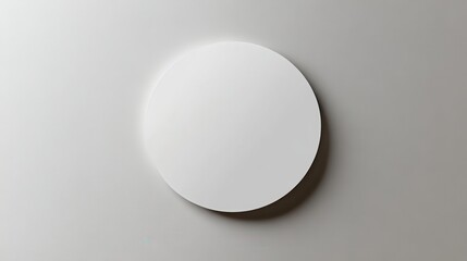 Minimalist round white wall clock on grey background with shadow