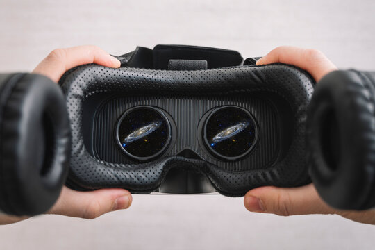 a man watching a video in virtual reality glasses. People and technology metaverse concept. 360 degree video viewing. outer space with vr glasses. Used a photo from the NASA collection