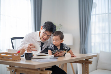 Father engaged in a learning activity with his baby at home during the day