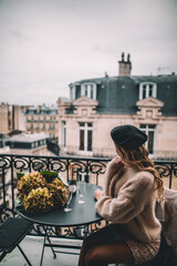 Woman enjoying the views of Paris from a balcony