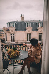 Woman enjoying the views of Paris from a balcony