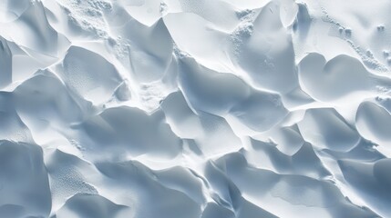 Obraz premium Aerial view of pristine white snow dunes textured by wind and light