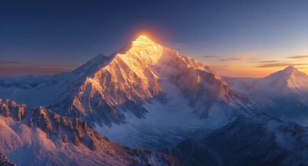 Obraz premium Snow-capped mountain peak illuminated by sunrise with a clear blue sky and rugged terrain in the foreground and background