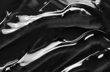 Transparent cosmetic moisturizing gel or skin serum on a black background