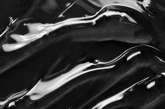 Transparent cosmetic moisturizing gel or skin serum on a black background