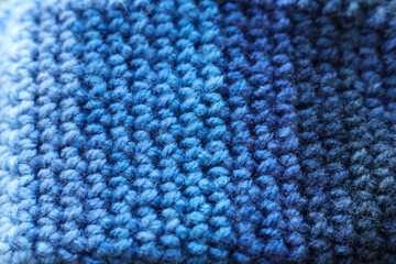 Closeup detail of crochet fabric texture background. Blue color
