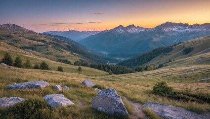 Naklejka premium Mountain landscape at sunset with rolling hills, rocky foreground, and distant peaks under a colorful sky. High-resolution nature scenery.