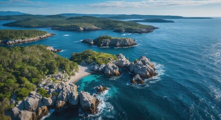 Fototapeta premium Coastal landscape with rocky shorelines, turquoise waters, and green islands under a clear blue sky. Aerial view of natural scenery.