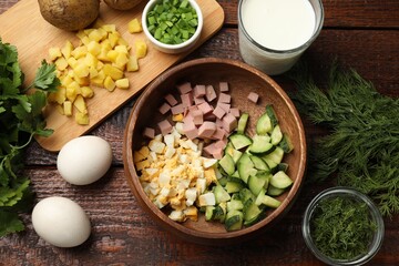 Different ingredients for okroshka soup on wooden table, flat lay