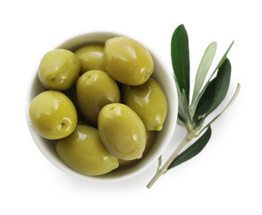 Delicious marinated green olives in bowl and leaves isolated on white, top view