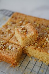 Eggless Semolina or Rava cake topped with nuts, selective focus
