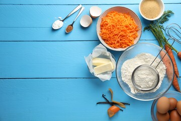 Different ingredients for making carrot cake on light blue wooden table, flat lay. Space for text