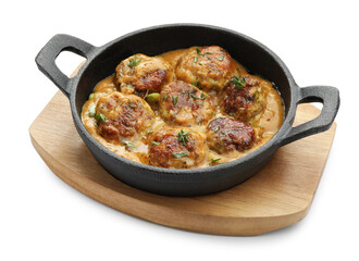 Delicious meatballs with gravy cream sauce and herbs isolated on white