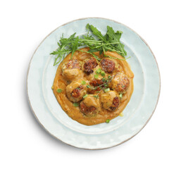Delicious meatballs with gravy cream sauce, herbs and arugula isolated on white, top view