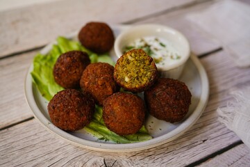 Homamade Falafel served with yogurt dip, selective focus