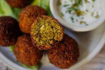 Homamade Falafel served with yogurt dip, selective focus