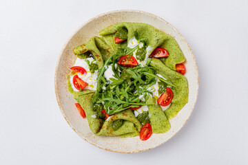 spinach pancakes with arugula and cherry tomatoes