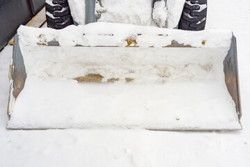 Snow removal tractor, bulldozer, for clearing, snow drifts. Public services for snow removal.