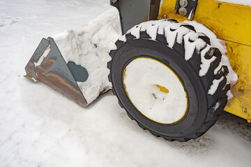 Snow removal tractor, bulldozer, for clearing, snow drifts. Public services for snow removal.
