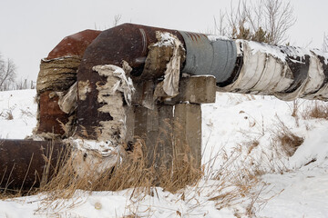 Overground heat pipes. Pipeline above the earth conducting heat for heating city. A snowy winter day