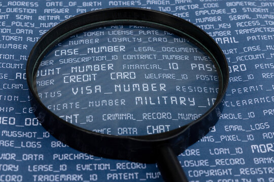 A symbolic representation of cybersecurity threats, featuring a magnifying glass highlighting personal information on a document, emphasizing data privacy.