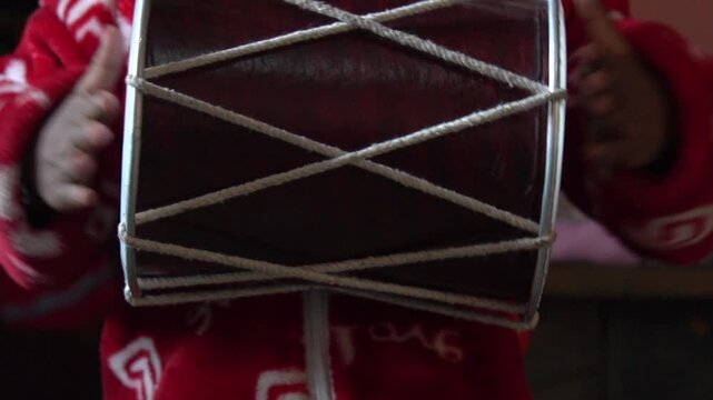 The dholak is a barrel-shaped, two‑headed South Asian hand‑drum, offering bass and treble tones, used in folk, devotional music