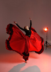 Beautiful young woman dancer dancing. dance elements photoshoot. Dancer in long skirt spanish dance