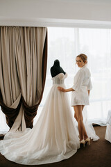 Fototapeta premium black-haired bride girl getting ready in boudoir