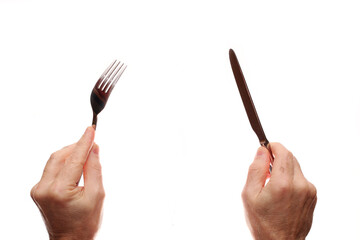 Knife and fork in hands on a white background.