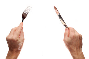 Knife and fork in hands on a white background.