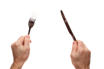 Knife and fork in hands on a white background.
