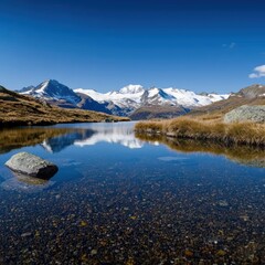 Fototapeta premium Crystal-clear alpine lake reflecting snow-capped mountains, serene and untouched nature, high-resolution detail