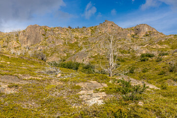 Torres del Paine national park mountain landscape in Patagonia, Chile. Los Cuernos and Torres del Paine peak granite towering summits on a nasty and sunny day above the blue water lake in the Andes