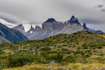 Obraz premium Torres del Paine national park mountain landscape in Patagonia, Chile. Los Cuernos and Torres del Paine peak granite towering summits on a nasty and sunny day above the blue water lake in the Andes