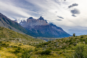 Fototapeta premium Torres del Paine national park mountain landscape in Patagonia, Chile. Los Cuernos and Torres del Paine peak granite towering summits on a nasty and sunny day above the blue water lake in the Andes