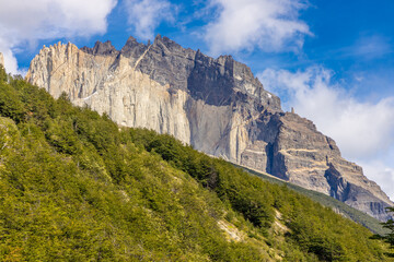 Torres del Paine national park mountain landscape in Patagonia, Chile. Los Cuernos and Torres del Paine peak granite towering summits on a nasty and sunny day above the blue water lake in the Andes