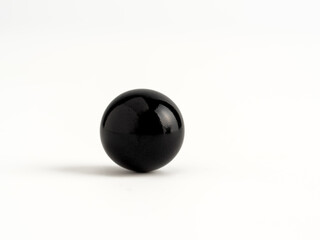 Solid black glass marble sphere ball  isolated on a white background