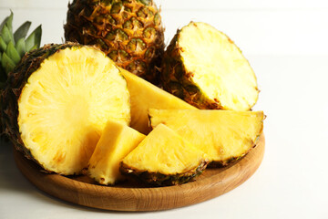 Fresh ripe pineapples on white table, closeup
