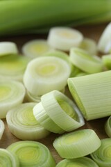 Fresh chopped leeks on wooden board, closeup
