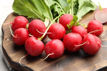 Many fresh radishes on grey table, closeup