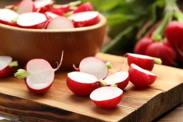 Fresh cut radishes on wooden table, closeup